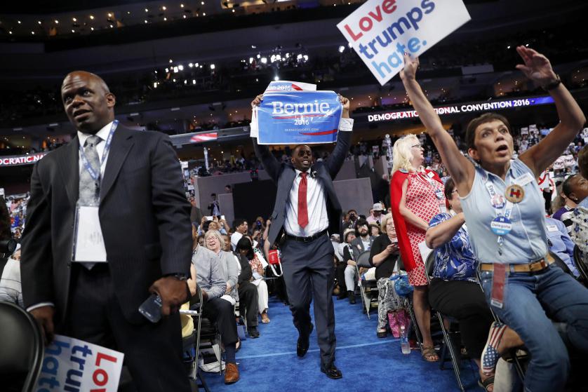 Attendees hold signs at the Democratic National Convention in Philadelphia